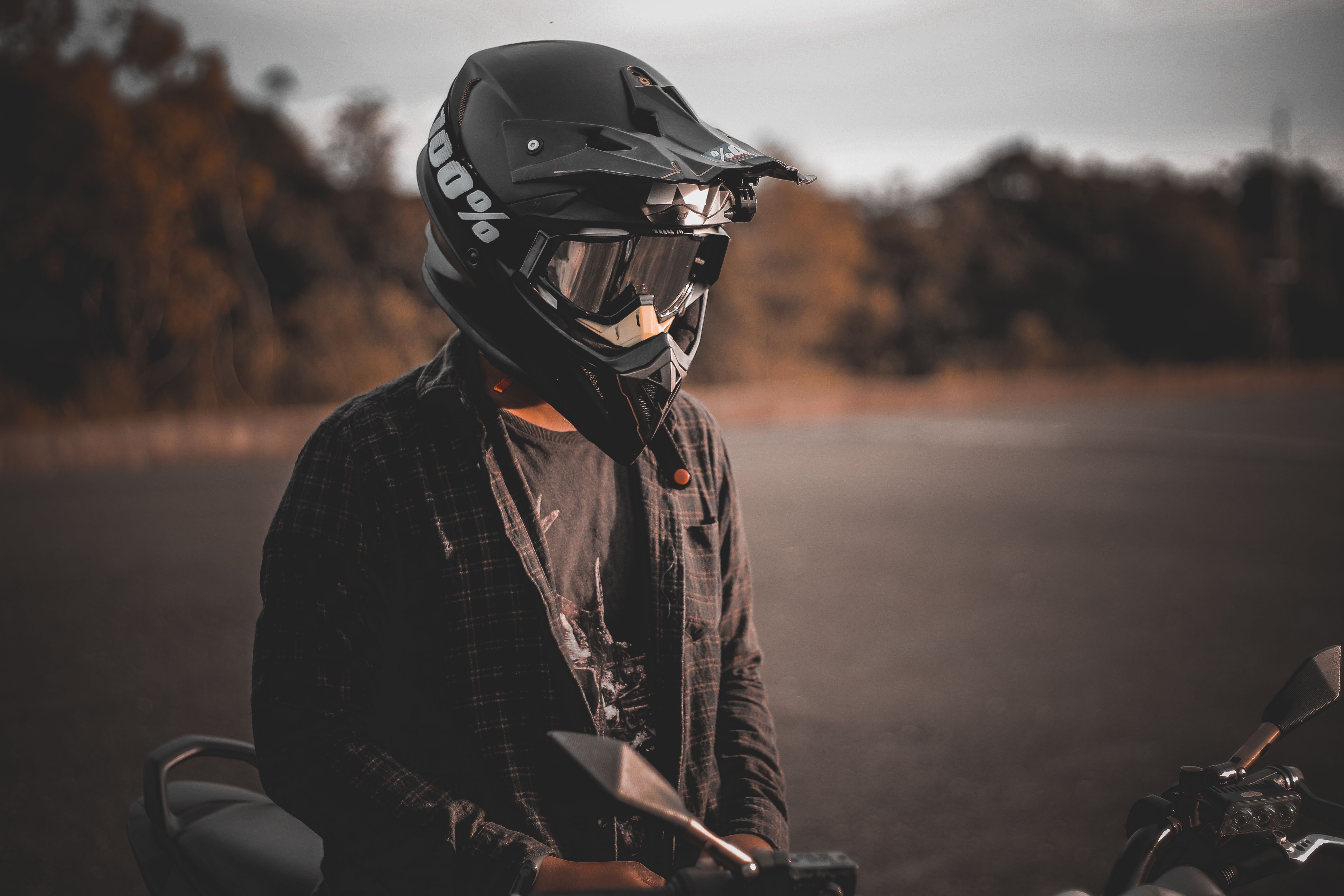 Motorcyclist wearing a full-face touring helmet riding at sunset